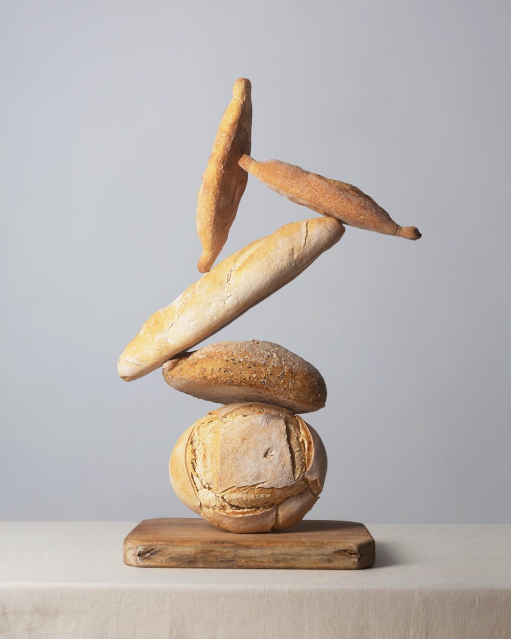 Balancing Bread on a table covered with a tablecloth